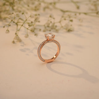Side view of Reia's Golden Promise Round Diamond Ring in 14KT rose gold, featuring a dual pave band and a brilliant round-cut EF-VVS lab-grown diamond.