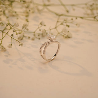 Side view of Reia's Eternal Flow Oval Diamond Ring in 14KT white gold, featuring a curved pave band and an EF-VVS oval-cut lab-grown diamond.