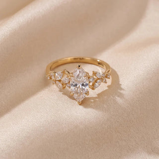 Top view of a 14KT Yellow Gold ring with a marquise-cut diamond and marquise-cut side diamonds.