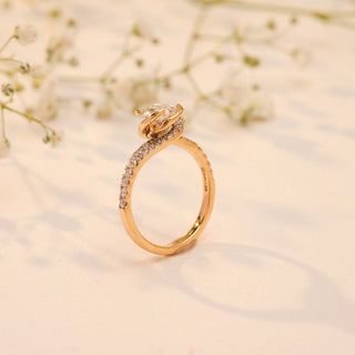 Side view of Reia's Celeste Embrace Solitaire Diamond Ring in 14KT yellow gold featuring a round-cut lab-grown diamond and pave-set shoulders.