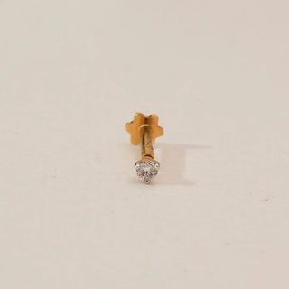Front view of round solitaire lab-grown diamond nosepin in yellow gold, featuring a single prong-set diamond with a minimal polished design on a soft neutral background.