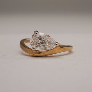 Front close-up of Reia 14KT Yellow Gold Teardrop Solitaire Ring showcasing a 1.25 carat pear-shaped EF VVS diamond, secured in a sleek prong setting for timeless brilliance and luxury.