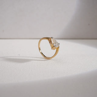 Angle view of Reia 14KT Yellow Gold Teardrop Solitaire Ring featuring a 1.25 carat EF VVS pear-shaped diamond in a sleek prong setting, radiating brilliance and timeless elegance.