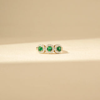 Front view of a Three-Stone Green Emerald Diamond Ring in 14KT Yellow Gold, featuring three vivid green emerald-cut gemstones.
