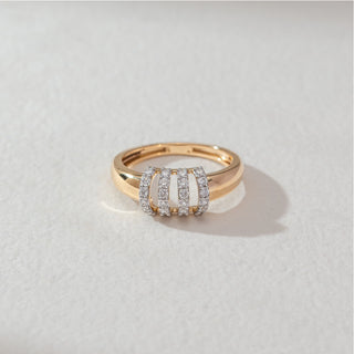 Top view of multi-row diamond band ring in yellow gold, featuring four vertical rows of round lab-grown diamonds across a polished band. Set on a soft neutral surface, it reflects bold structure and refined sparkle.