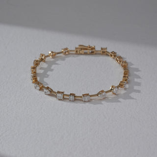 Angled view of Geometric Diamond Bracelet in 14KT Dual Gold, featuring alternating square and round lab grown diamonds in prong setting. Set on a neutral backdrop, the design highlights modern symmetry and brilliance.
