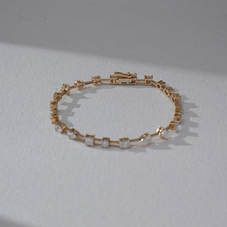 Top view of Geometric Diamond Bracelet in 14KT Dual Gold, featuring alternating square and round lab grown diamonds in prong setting. Set on a beige backdrop, the design highlights clean symmetry and modern elegance.
