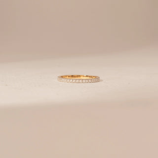Front view of a 14KT Yellow Gold diamond ring, featuring a full band of closely set round diamonds.