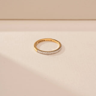 Side view of a 14KT Yellow Gold diamond ring, featuring a full band of closely set round diamonds.