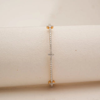Front view of yellow gold diamond bangle lined with round lab grown diamonds, highlighted by delicate floral cluster motifs along a sleek linear silhouette on a neutral display.