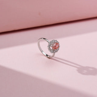 Angled view of Majestic Crimson Halo Diamond Ring in 14KT White Gold, featuring an oval red lab-grown diamond with a diamond halo.