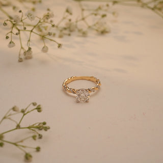 Top view of Reia's Lover's Knot Solitaire Diamond Ring, showcasing the elegant twisted pave band and radiant round-cut lab-grown diamond.