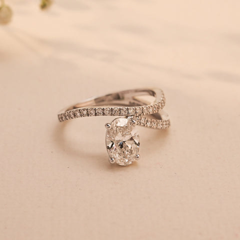 Top view of the Eternal Flow Oval Diamond Ring by Reia, showcasing a flowing pave band encircling a luminous oval-cut lab-grown diamond.