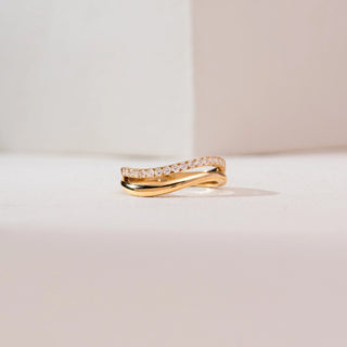Front view of Wave Bypass Pavé Diamond Ring in 14KT yellow gold, showcasing intertwined curves with one band set in round pavé diamonds for a sleek, elegant shine.