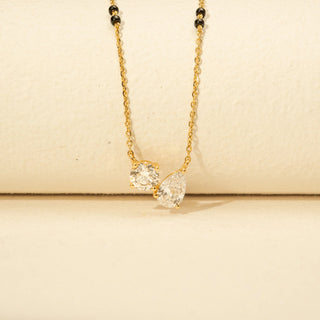 Close-up view of Diamond Mangalsutra Necklace in 14KT Yellow Gold, featuring round and pear-shaped diamonds with black beads.
