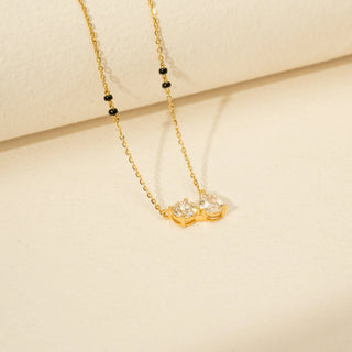 Side view of Diamond Mangalsutra Necklace in 14KT Yellow Gold, featuring round and pear-shaped diamonds with black beads.