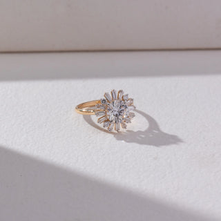 Top view of Sunburst Cluster Diamond Ring in 14KT Yellow Gold, featuring a round lab grown diamond centre with baguette accents radiating outward. Set on a beige backdrop, the design highlights brilliance and symmetry.
