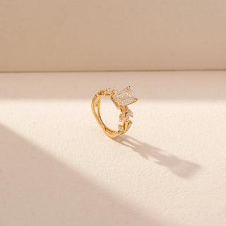 Angled view of Emerald-Cut Diamond Ring in 14KT Yellow Gold, featuring an emerald-cut centre diamond and floral side accents.