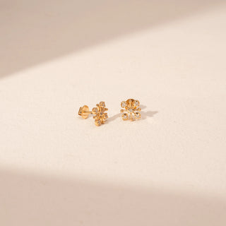 Angled view of Sunburst Diamond Stud Earrings in 18KT Yellow Gold, featuring round lab-grown diamonds and gold rays.