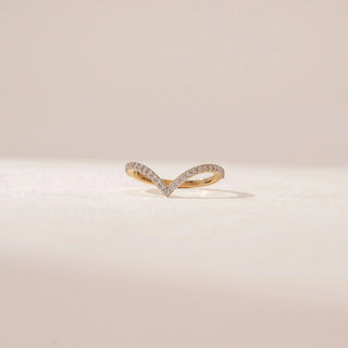 Close-up view of a 14KT Yellow Gold diamond ring featuring a V-shaped band set with small round diamonds.