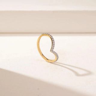 Angled view of a 14KT Yellow Gold diamond ring featuring a V-shaped band set with small round diamonds.