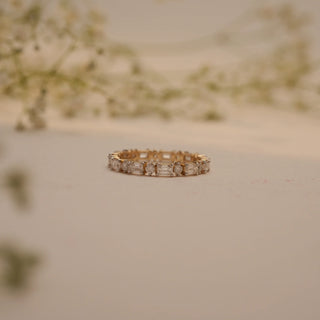 Close-up of Reia's Gilded Harmony Diamond Band in 14KT yellow gold, adorned with alternating baguette and round-cut lab-grown diamonds.