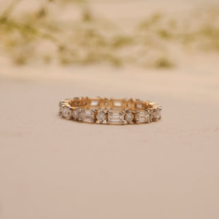 Close-up of Reia's Gilded Harmony Diamond Band in 14KT yellow gold, adorned with alternating baguette and round-cut lab-grown diamonds.