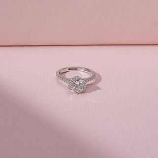 Top view of a solitaire diamond ring in 14KT white gold, featuring a round lab-grown diamond and pavé band.