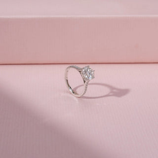 Angled view of a solitaire diamond ring in 14KT white gold, featuring a round lab-grown diamond and pavé band.