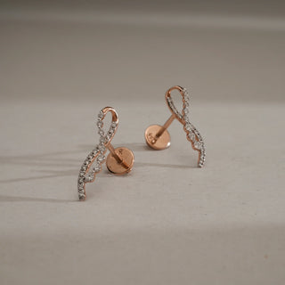 Pair of Cascading Vine Diamond Drop Earrings in 14KT Rose Gold, featuring delicately curved vine-inspired design set with sparkling round lab-grown diamonds, displayed with Bombay screw backs on a neutral surface.