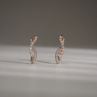 Front view of Cascading Vine Diamond Drop Earrings in 14KT Rose Gold, featuring delicate vine-like curves set with round lab-grown diamonds, displayed upright on a neutral surface with soft shadows.