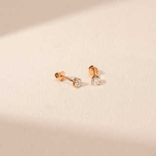 Angled view of Round Diamond Stud Earrings in 14KT Yellow Gold, featuring round lab-grown diamonds with screw-back settings.