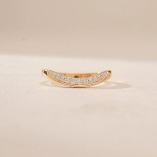 Front view of a 14KT Yellow Gold diamond ring, featuring a curved band with a row of round diamonds.