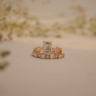 Front view of the Gilded Harmony Emerald Diamond Ring by Reia, showcasing a radiant emerald-cut EF-VVS lab-grown diamond flanked by marquise side stones.