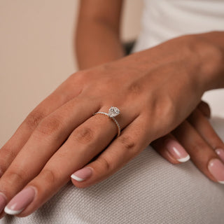 Reia's Eternal Teardrop Solitaire Diamond Ring worn on hand, showcasing a pear-cut lab-grown diamond on a slim gold band, captured under warm light for an elegant bridal look.