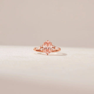 Front view of a 14KT Rose Gold ring featuring a pink oval-cut centre diamond with marquise and round diamond side accents.