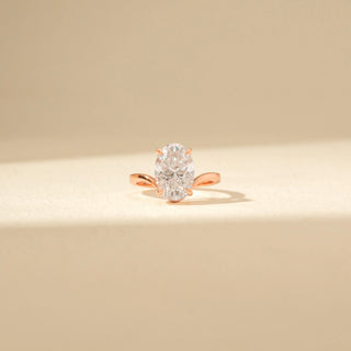 Front view of Oval Solitaire Diamond Ring in 14KT Rose Gold, featuring an oval-cut diamond and twisted band.