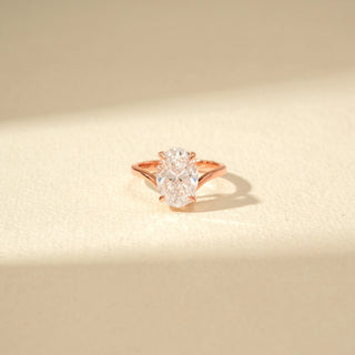 Close-up view of Oval Solitaire Diamond Ring in 14KT Rose Gold, featuring an oval-cut diamond and twisted band.