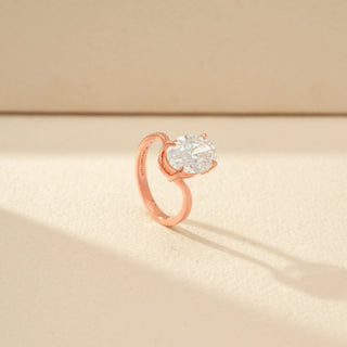 Angled view of Oval Solitaire Diamond Ring in 14KT Rose Gold, featuring an oval-cut diamond and twisted band.