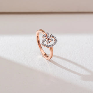 Side angled view of floral diamond ring in rose gold, featuring round lab-grown diamonds in a blooming cluster within a teardrop frame lined with diamonds. Set on a soft neutral backdrop, it highlights delicate elegance.