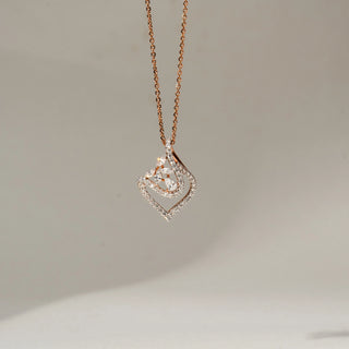 Front view of a rose gold pendant necklace featuring an open diamond-studded teardrop frame with a sparkling floral motif at the center, suspended from a delicate chain.