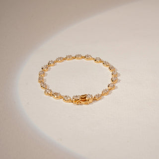 Top view of a 14KT Yellow Gold diamond bracelet, featuring pear, oval and emerald-cut diamonds in a link design.