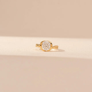 Front view of Round Solitaire Diamond Ring in 14KT Yellow Gold, featuring a bezel-set round diamond with a curved band.