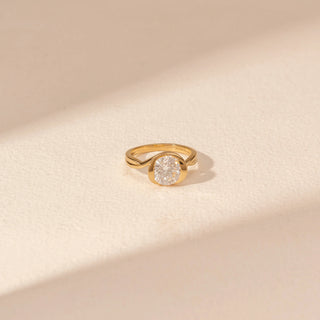 Top view of Round Solitaire Diamond Ring in 14KT Yellow Gold, featuring a bezel-set round diamond with a curved band.