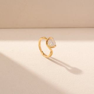 Angled view of Round Solitaire Diamond Ring in 14KT Yellow Gold, featuring a bezel-set round diamond with a curved band.