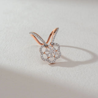 Top view of floral butterfly diamond ring in rose gold, featuring round lab-grown diamonds in a layered petal motif with diamond-studded dual bands. Set on a soft neutral surface, it highlights intricate sparkle.
