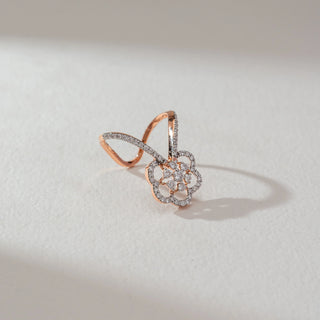 Side angled view of floral butterfly diamond ring in rose gold, featuring round lab-grown diamonds in a layered petal motif with diamond-studded dual bands. Set on a soft neutral backdrop, it highlights intricate brilliance.