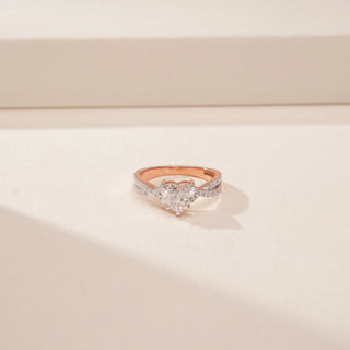 Close-up view of a 14KT Rose Gold diamond ring, featuring a cushion-cut centre diamond and diamond-set twisted shoulders.