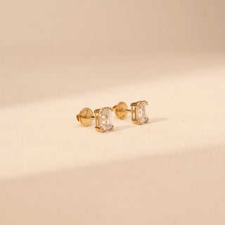 Side view of emerald-cut lab-grown diamond stud earrings in 14 KT yellow gold, featuring four-prong emerald-cut solitaire diamonds in a timeless minimalist design.