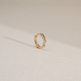 Angle view of the Delicate Petal Diamond Nose Pin in 14KT Yellow Gold, featuring marquise-cut EF VVS diamonds totalling 0.07 carats, designed in a minimal floral-inspired circular style.